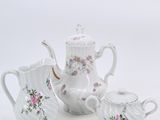 three pieces of porcelain tea set on a white background