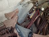 a pile of old bicycles and umbrellas in a room