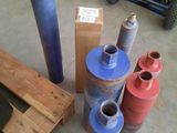 many rolls of plastic sitting on the floor next to a pallet