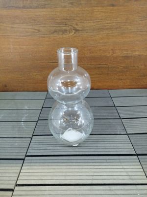 un vase en verre posé sur une table en bois
