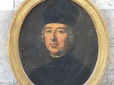 portrait of a man wearing a black hat and a black coat