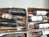 several bottles of wine are in a cardboard box on the floor