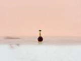 a small bottle of perfume sitting on a table