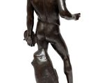 bronze statue of a man holding a rock on a white background