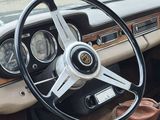 a steering wheel and dashboard of a car in a parking lot
