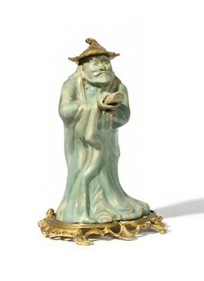 a figurine of a man with a hat and a cane