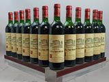 bottles of red wine are lined up on a metal rack