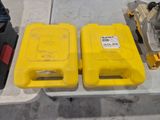 two yellow plastic containers sitting on top of a white table