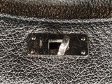 the inside of a black leather purse with a metal clasp