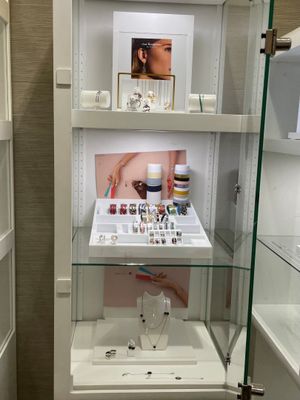 a glass display case in the corner of a bathroom