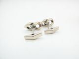 pair of silver cufflinks on a white background