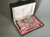 a box with a set of silver objects inside of it