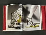 an open book with a picture of a woman ' s shoes on it