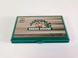 an image of a green house business card holder on a white surface