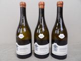 three bottles of wine sitting on top of a table next to each other