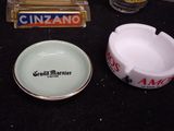 two ashtrays and a cigarette ashtray on a table