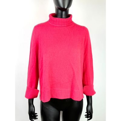 un mannequin vêtu d'un pull rose et d'un legging noir