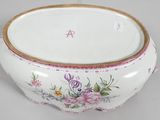 a white bowl with pink and yellow flowers on it