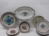 many plates and bowls that are sitting on a table
