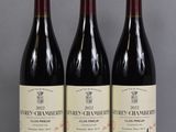 three bottles of wine are lined up on a table