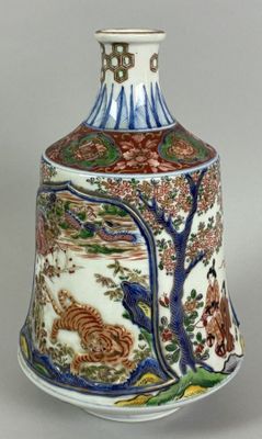 a vase with a design on it sitting on a table