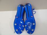 pair of blue soccer cleats sitting on top of a white counter