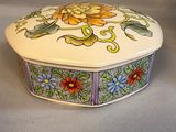 a decorative box with flowers on it on a table