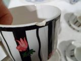 une personne tenant une tasse ornée d'une fleur