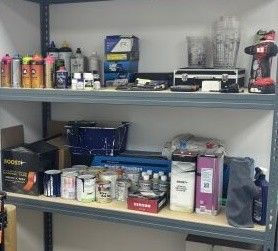 a shelf with many different types of paint and tools on it