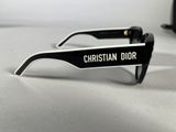 christian dior sunglasses with black and white frames on a white surface
