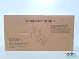 a cardboard box that has a computer desk in it