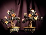 two bonsais that are sitting on a table