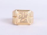 an image of a gold signet ring with arabic writing on it