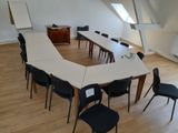 a room with a long table and chairs in it