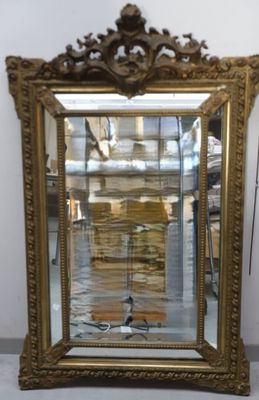 a mirror that is sitting on the floor in front of a wall