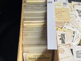 a wooden box filled with lots of cards and a bottle of wine