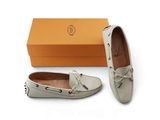a pair of white shoes with a box on the side