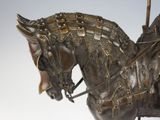 a bronze statue of a horse with a rider on it