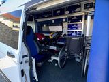 a wheelchair in the back of a van with the door open