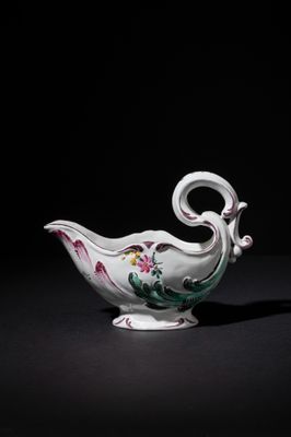 an image of a white and pink porcelain bowl on a black surface