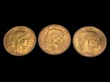 three gold sovereigns, one of which is a sovereign and one of which is a sovereign