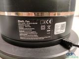 a close up of a black speaker on top of a table
