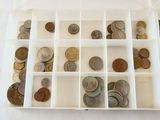 a white box filled with lots of coins on a table