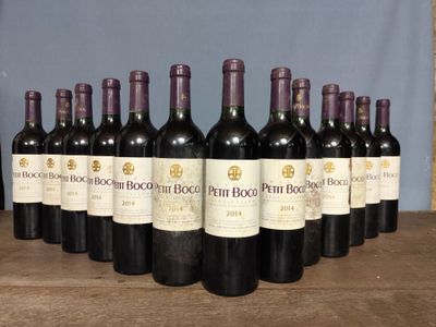 several bottles of wine are lined up on a wooden table