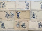 several old postcards with drawings of people on them on a wooden surface