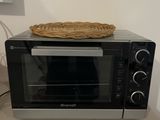 a toaster oven sitting on a counter with a basket on top of it