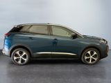 the blue car is parked in a room with a gray wall