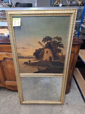un tableau représentant un moulin à vent dans un champ, avec un homme à cheval