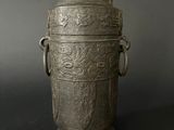 an old silver vase with handles and handles on a black background