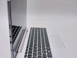 a white laptop with a black keyboard on a white surface